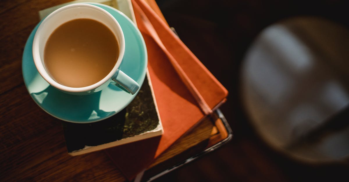 Visa requirement with a residence permit from Greece - From above of ceramic cup of hot aromatic coffee placed on book and notepad Visa requirement with a residence permit from Greece - From above of ceramic cup of hot aromatic coffee placed on book and notepad