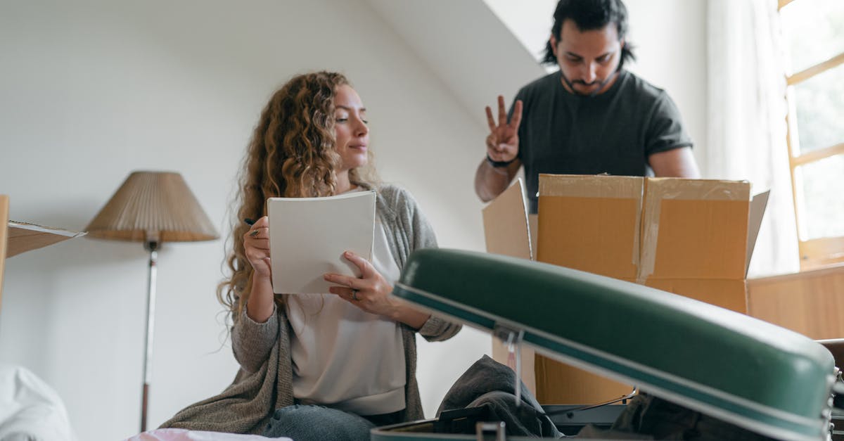 Visa requirements for check out and in - Focused couple packing stuff before moving out Visa requirements for check out and in - Focused couple packing stuff before moving out