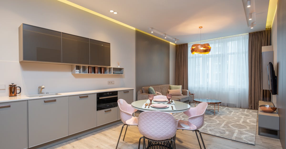 Visa requirements for Macedonia for Schengen-zone Permanent Residents? - Modern living room with cozy sofa near stylish kitchen zone and round glass dining table Visa requirements for Macedonia for Schengen-zone Permanent Residents? - Modern living room with cozy sofa near stylish kitchen zone and round glass dining table