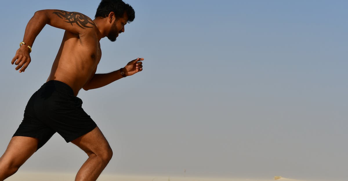 Visa run to Malaysia from Thailand - Strong shirtless sportsman jogging on bright day Visa run to Malaysia from Thailand - Strong shirtless sportsman jogging on bright day