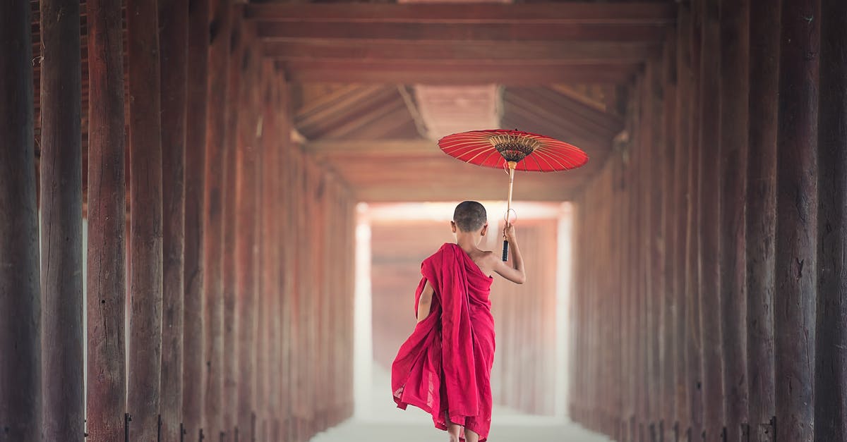 Visa to Japan for a Kazakstan citizens living in Shanghai [closed] - Boy Walking Between Wooden Frame While Holding Umbrella