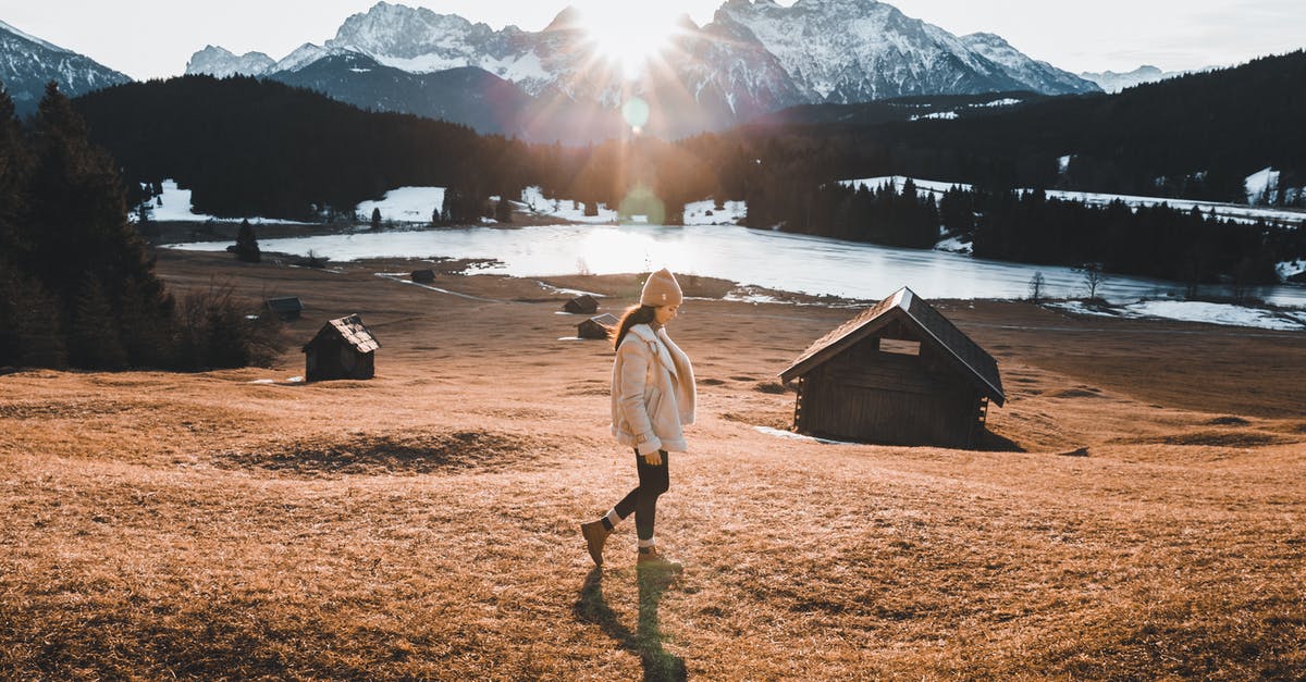 Visit Germany from Vietnam - Woman in Brown Coat Standing on Brown Grass Field Near Body of Water Visit Germany from Vietnam - Woman in Brown Coat Standing on Brown Grass Field Near Body of Water