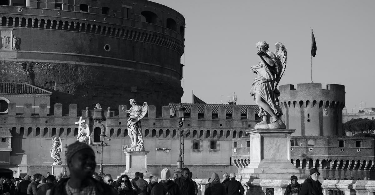 visit to Rome with Croatian Visa - Black and white crowd of diverse travelers walking on bridge with marble statues near famous ancient Castel Sant Angelo on sunny day in Rome visit to Rome with Croatian Visa - Black and white crowd of diverse travelers walking on bridge with marble statues near famous ancient Castel Sant Angelo on sunny day in Rome
