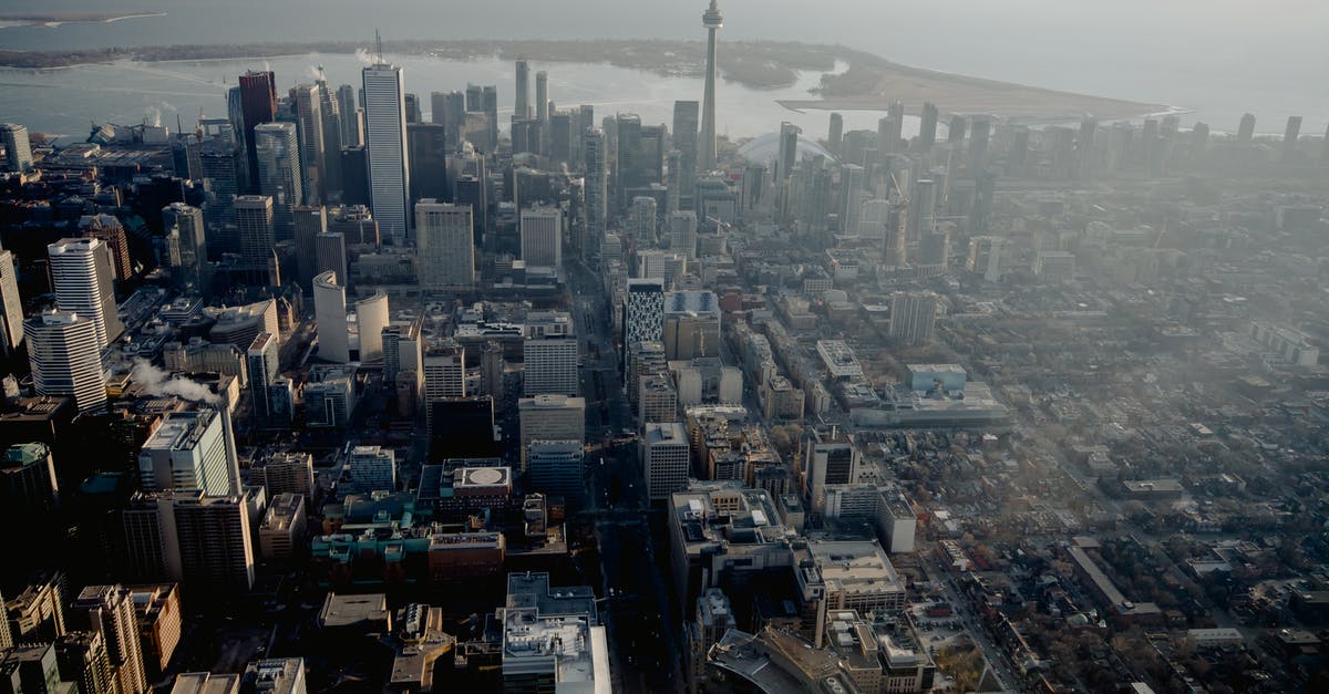 Visitation and Permanent residence in Canada [closed] - Aerial view of megapolis streets with residential buildings and office skyscrapers on river coast in Canada