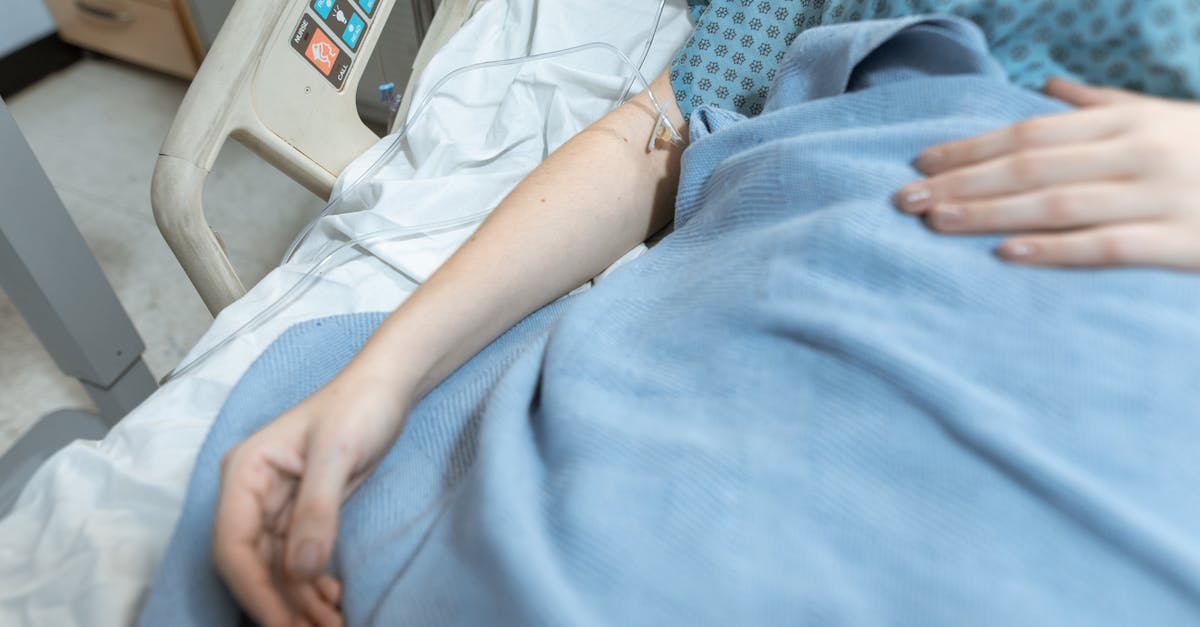 Visiting doctors while staying in Australia? - Person in White Shirt Lying on Hospital Bed Visiting doctors while staying in Australia? - Person in White Shirt Lying on Hospital Bed