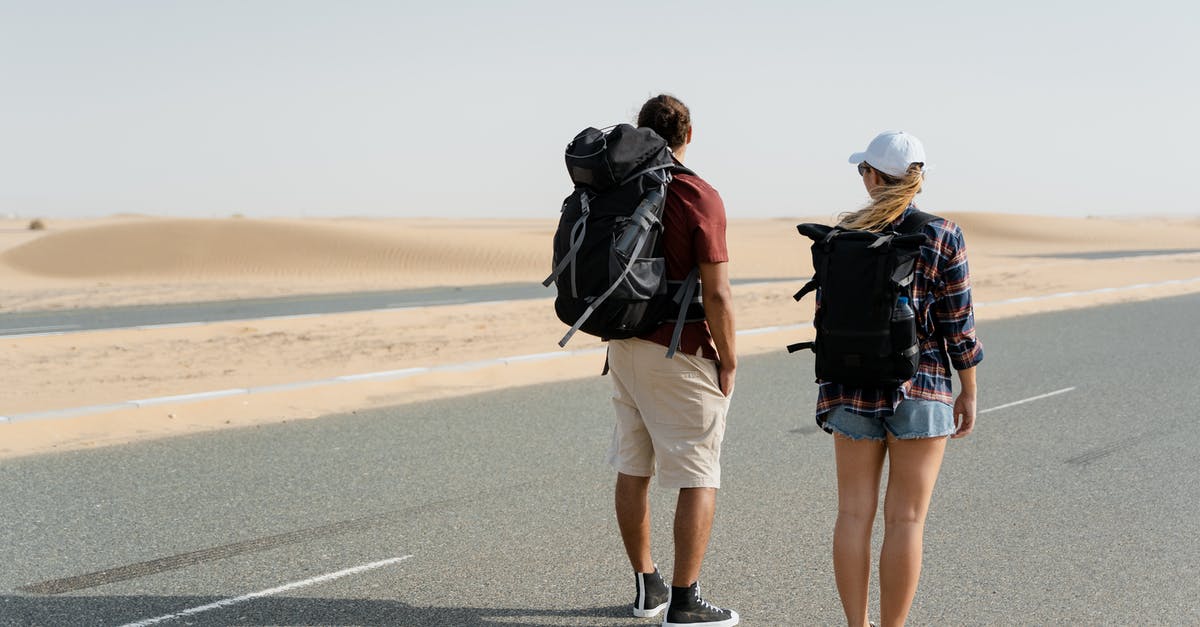 Visiting Dubai as an unmarried couple [duplicate] - Couple Standing on the Road near the Desert