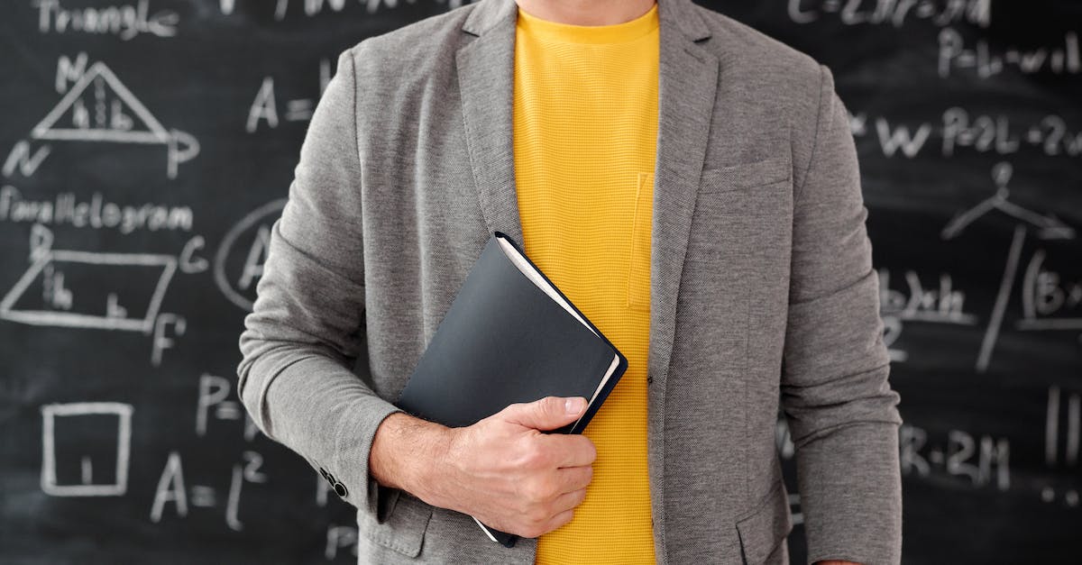 Visiting Formula 1 Monaco GP on a tight budget - Man in Gray Blazer Holding Black Book Visiting Formula 1 Monaco GP on a tight budget - Man in Gray Blazer Holding Black Book
