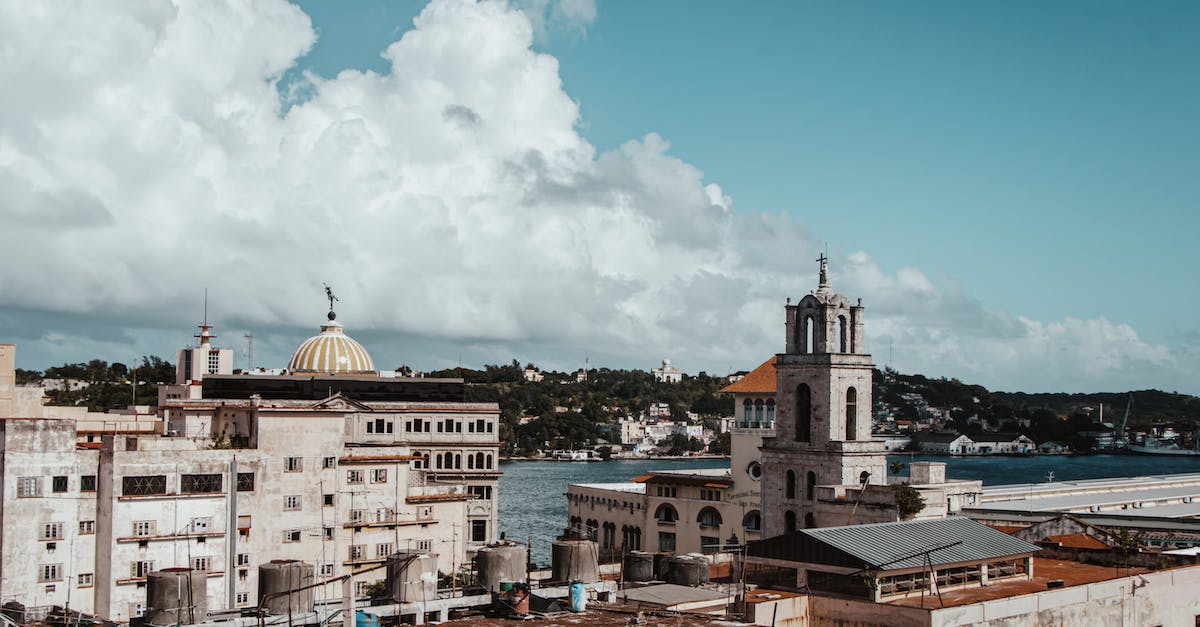 Visiting islands around Cuba - Old church and building facades against ocean on island Visiting islands around Cuba - Old church and building facades against ocean on island