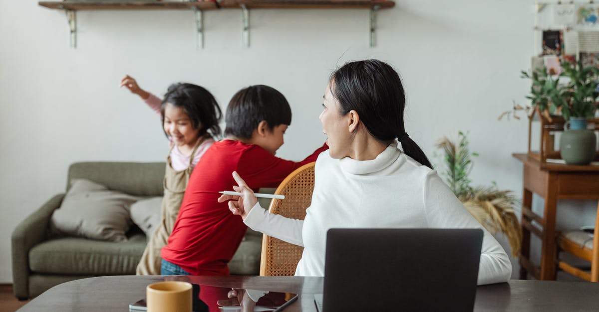 visiting mom from Romania to Canada - Young Asian working mother scolding little kids playing and making noise during remote job at home visiting mom from Romania to Canada - Young Asian working mother scolding little kids playing and making noise during remote job at home