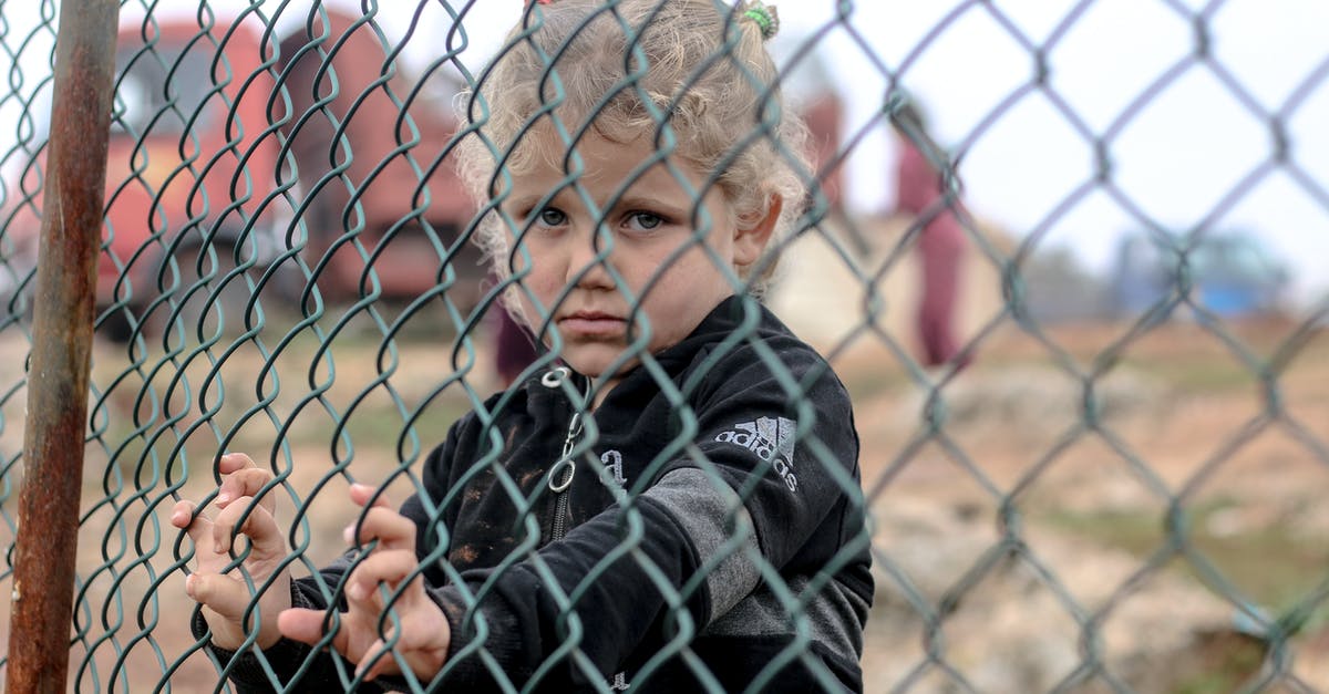 Visiting relatives in Canada for 2-3 months, need I be worried about the stuff I bring along? - Little ethnic boy standing near net fence