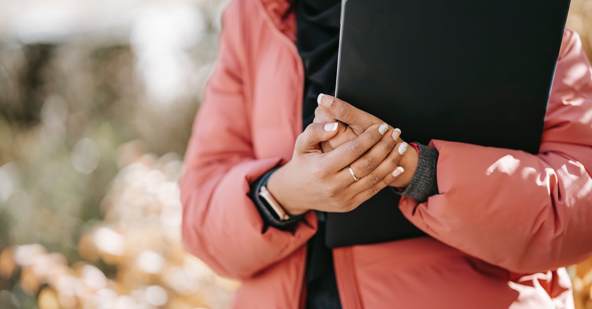 Visiting South Africa twice for 90 days while I wait for my study permit? - Female freelancer standing with netbook in hands on street Visiting South Africa twice for 90 days while I wait for my study permit? - Female freelancer standing with netbook in hands on street
