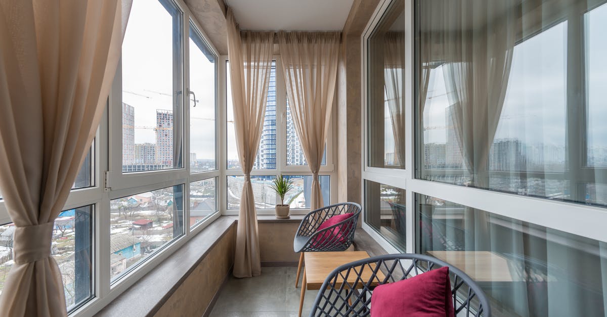 Visiting the housing projects in New York City? - Chairs and coffee table placed in patio of contemporary apartment Visiting the housing projects in New York City? - Chairs and coffee table placed in patio of contemporary apartment
