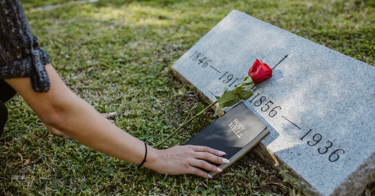 Visiting the UK while holding a visa that I no longer meet the requirements for - A Person holding Holy Bible in the Cemetery