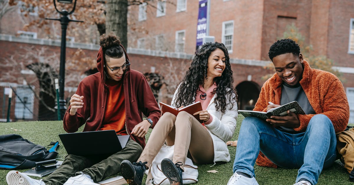 Visitor visa refusal for student friend - Full body of happy diverse students with notebooks and laptop sitting on grassy lawn on campus of university while studying together Visitor visa refusal for student friend - Full body of happy diverse students with notebooks and laptop sitting on grassy lawn on campus of university while studying together