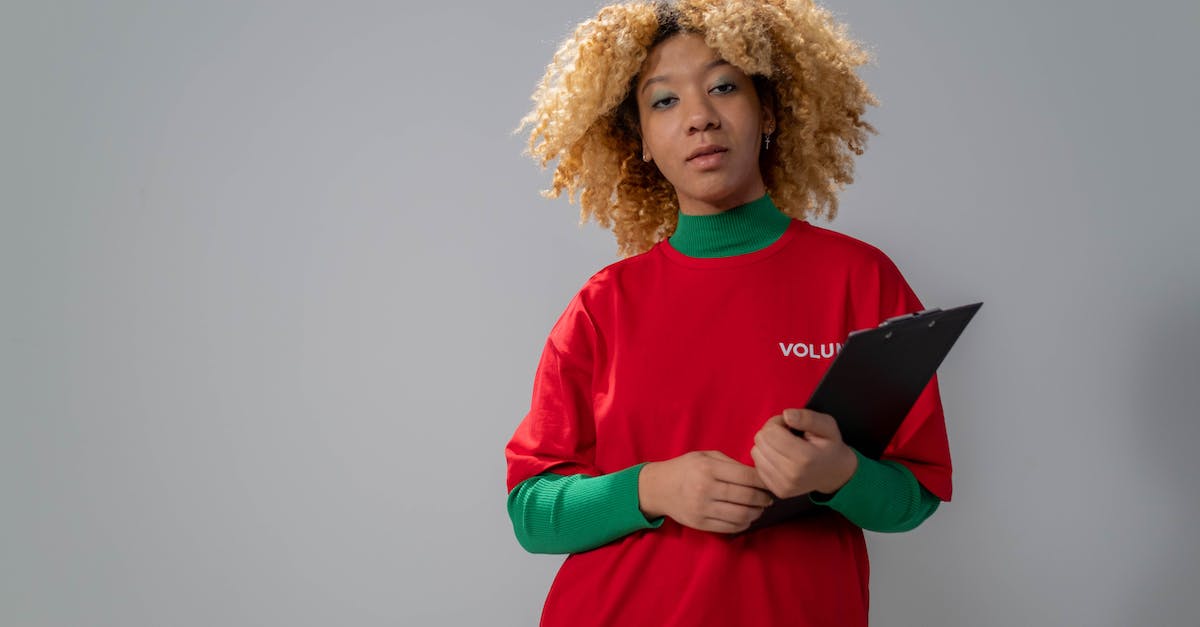 Volunteering opportunities when travelling overseas - Woman in Red Long Sleeve Shirt Holding Black Book Volunteering opportunities when travelling overseas - Woman in Red Long Sleeve Shirt Holding Black Book
