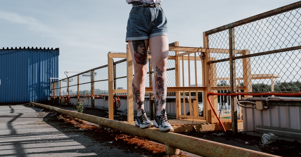 Walking across Australia? - Man in Grey Shirt and Blue Denim Shorts Standing on Brown Wooden Bridge Walking across Australia? - Man in Grey Shirt and Blue Denim Shorts Standing on Brown Wooden Bridge