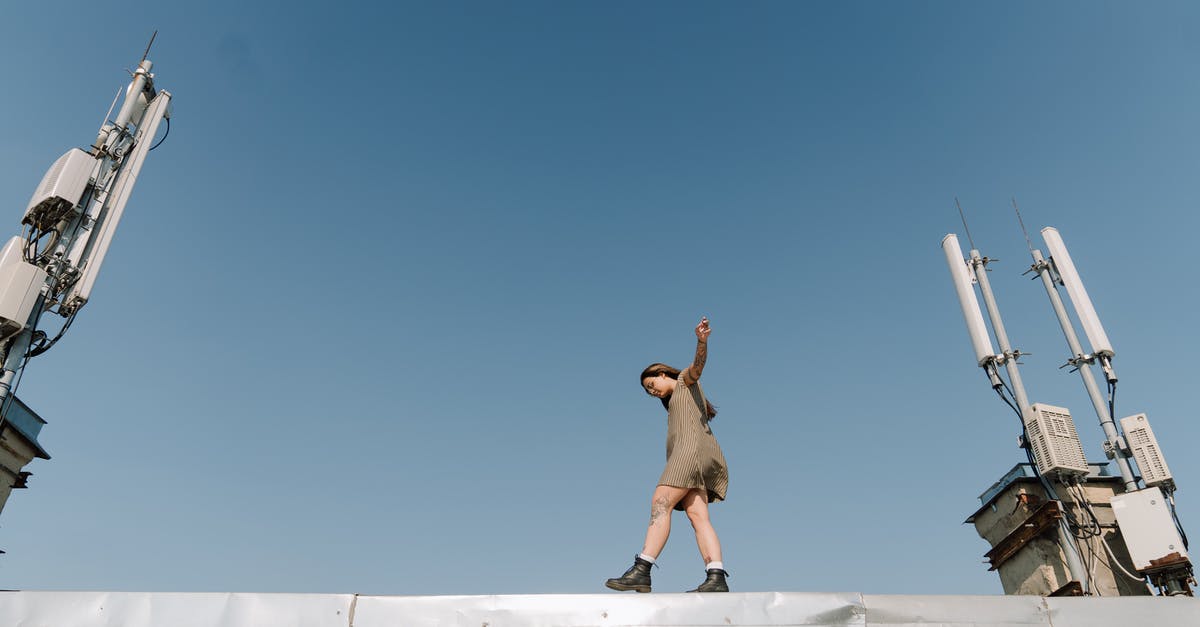 Walking from Santiago to Buenos Aires - Man in Brown Shorts Jumping on White Concrete Building Walking from Santiago to Buenos Aires - Man in Brown Shorts Jumping on White Concrete Building