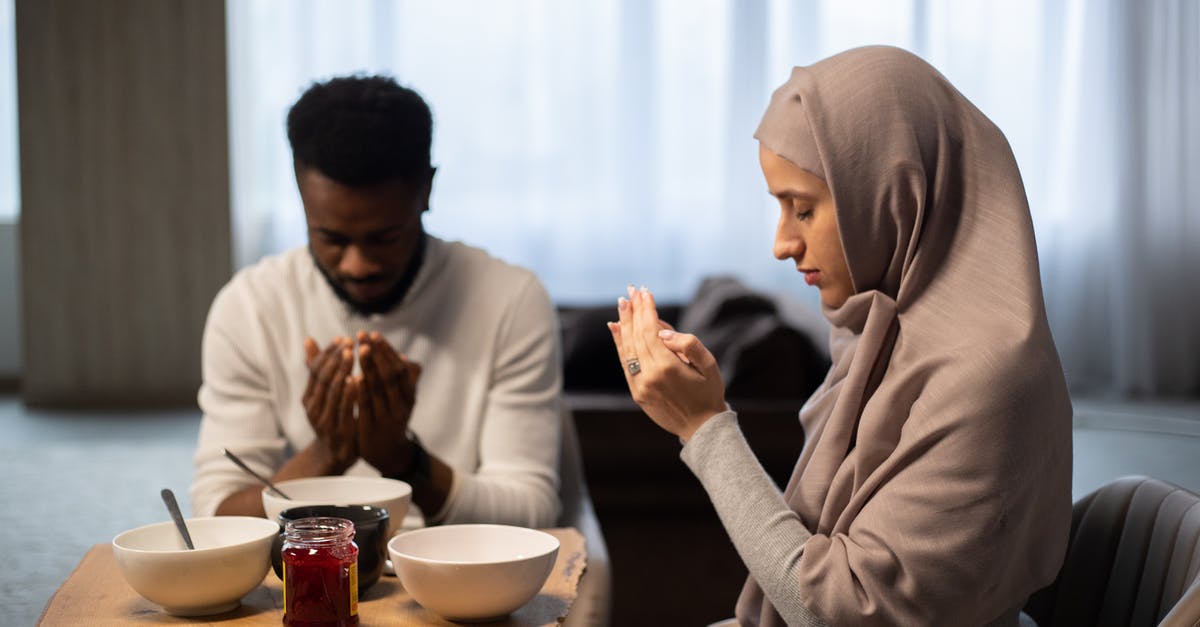 Was American Airlines correct to refuse me boarding through Narita? [closed] - Multiethnic couple praying at table before eating