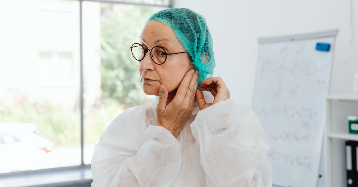 Wearing neoprene suit in airplane? - Woman in White Robe Wearing Eyeglasses Wearing neoprene suit in airplane? - Woman in White Robe Wearing Eyeglasses