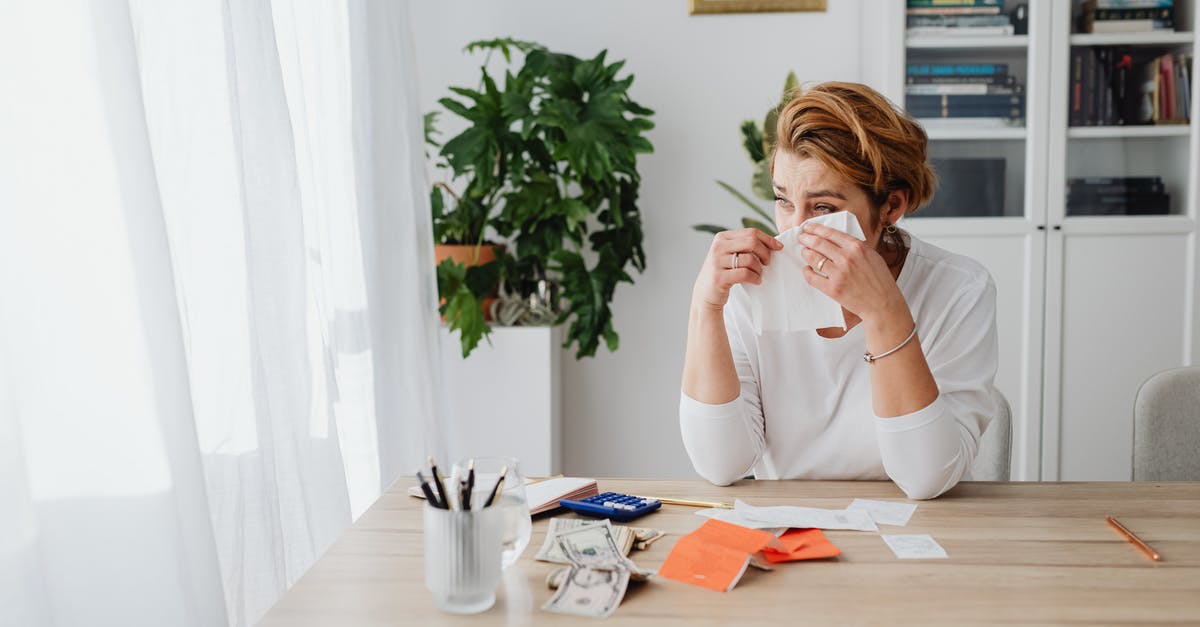 Weird points calculation at Qantas Frequent Flyer - Woman in an Office with Banknotes on Table, Crying Weird points calculation at Qantas Frequent Flyer - Woman in an Office with Banknotes on Table, Crying