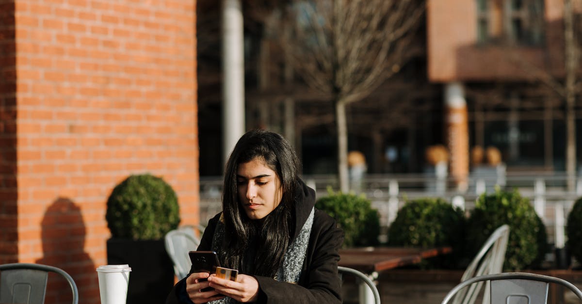 What's the cheapest SIM card with Internet for smartphone in Czech Republic? [duplicate] - Young attentive Hispanic female buyer with cellphone and credit card shopping online in urban cafeteria