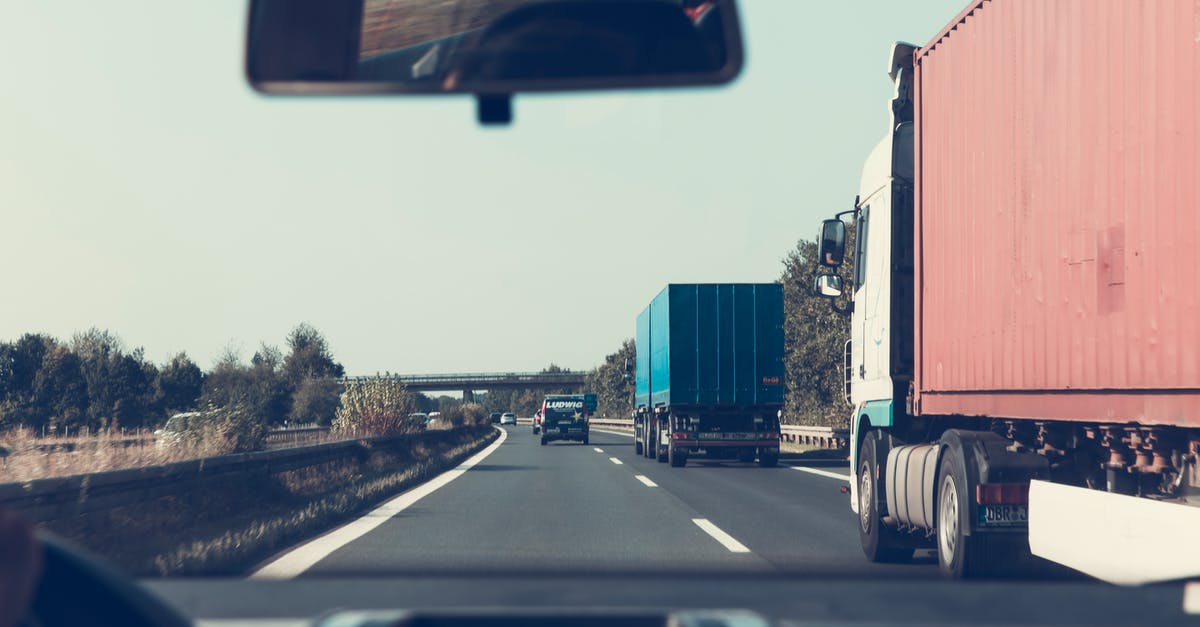 What's the cheapest way of traveling between Cambridge and Sheffield, UK? [closed] - Blue and Red Freight Truck on Road