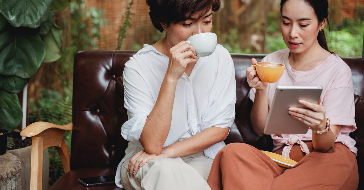 What's the use of trains that spend 6+ hours of daytime en route? [closed] - Thoughtful Asian women in casual clothes drinking cups of beverage and looking at screen of tablet