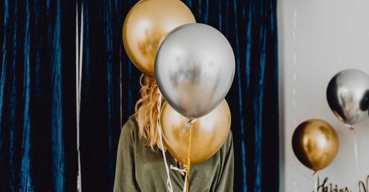 What's this celebration in Japan? - Woman in Black Jacket Holding White and Blue Balloons What's this celebration in Japan? - Woman in Black Jacket Holding White and Blue Balloons