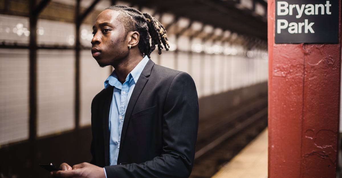 What's with NYC hotel prices in late March? - Young worried African American male commuter in formal suit with smartphone in hands waiting for train at New York subway station What's with NYC hotel prices in late March? - Young worried African American male commuter in formal suit with smartphone in hands waiting for train at New York subway station