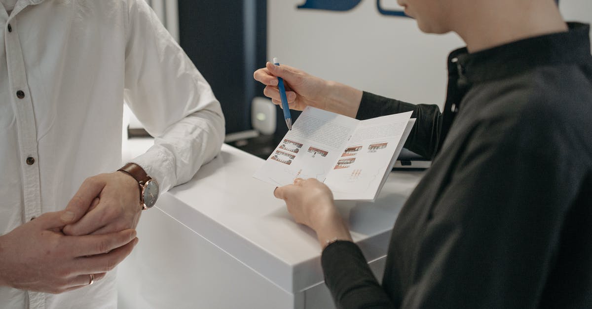 What are frequent flyer awards? - A Woman Explaining the Contents of the Brochure What are frequent flyer awards? - A Woman Explaining the Contents of the Brochure