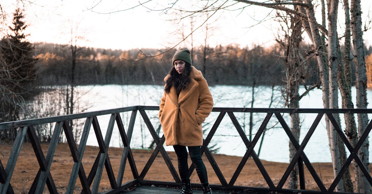 What are logistics like for a solo skier visiting Salt Lake City/Park City? [closed] - Woman in Brown Coat Standing on Wooden Deck