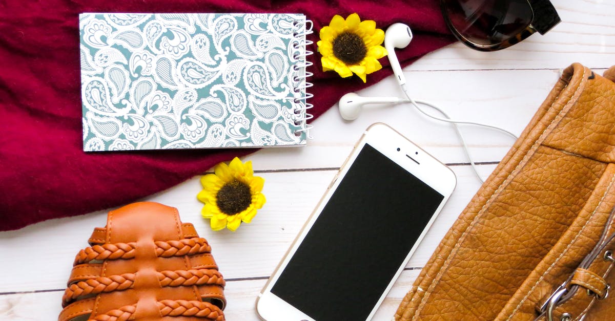 What are some good shoe options for a RTW trip? - Flat Lay Photography of Iphone, Notebook, and Retractable Pen