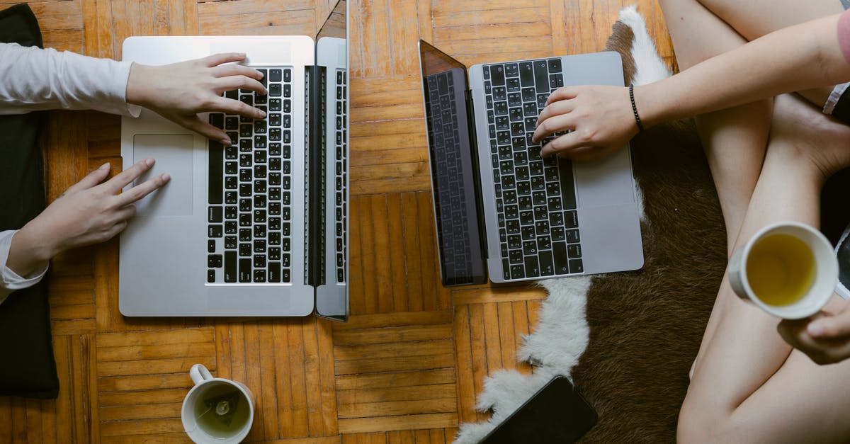 What are some remote places to live with reliable (wired) high-speed broadband internet? [closed] - From above of crop unrecognisable female friends typing while studying on laptops remotely and enjoying tea on floor in cozy living room