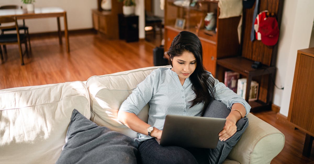 What are some remote places to live with reliable (wired) high-speed broadband internet? [closed] - From above of young ethnic woman with long dark hair in casual clothes sitting on sofa and surfing internet on netbook while working remotely in cozy living room