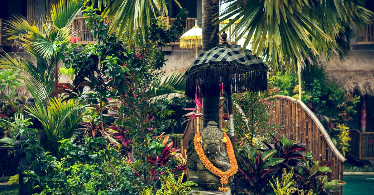 What are some significant places of un-touched natural beauty, traditional culture and history in Thailand? [closed] - Statue With Orange Necklace Surrounded by Plants and Trees