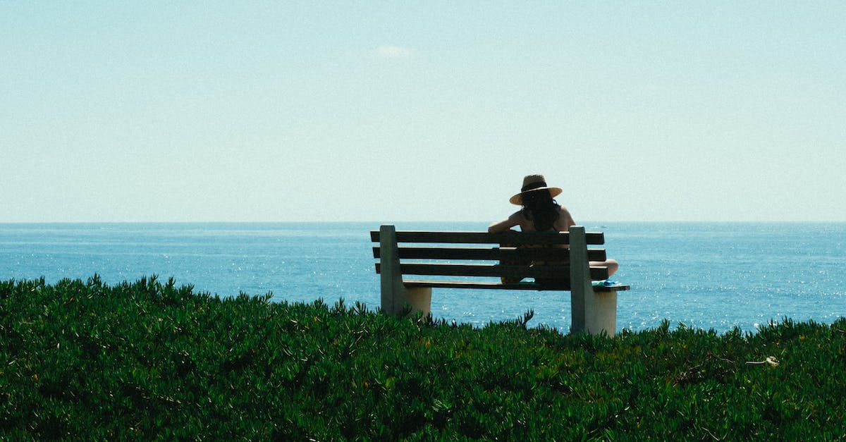 What are some strategies for keeping solo travel costs down? - Woman Sitting on Bench on Grass Shore during Day What are some strategies for keeping solo travel costs down? - Woman Sitting on Bench on Grass Shore during Day