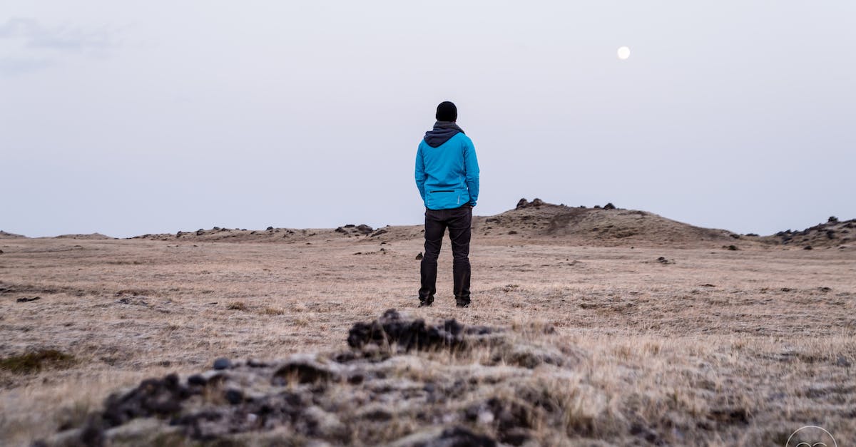 What are some strategies for keeping solo travel costs down? - Man in Blue Hoodie Standing on Brown Grass What are some strategies for keeping solo travel costs down? - Man in Blue Hoodie Standing on Brown Grass