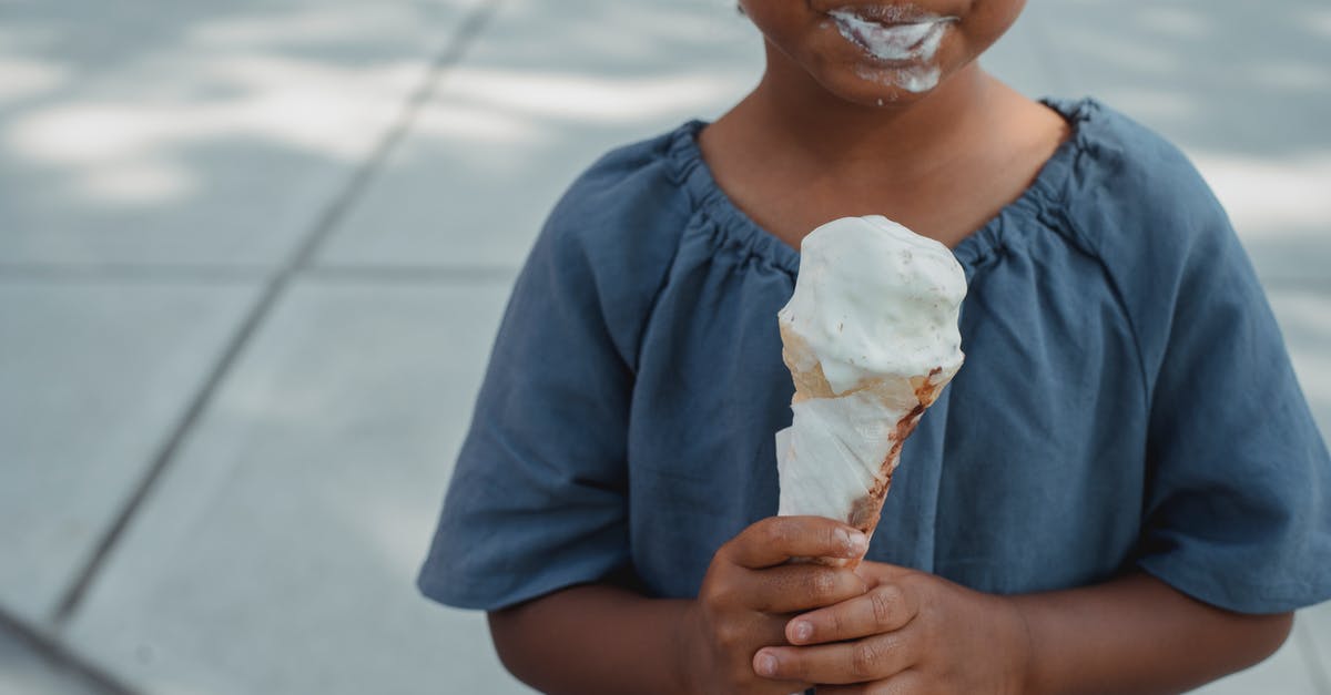 What are some tips for a child flying alone for the first time? - Little child with dirty mouth standing with ice cream on street What are some tips for a child flying alone for the first time? - Little child with dirty mouth standing with ice cream on street