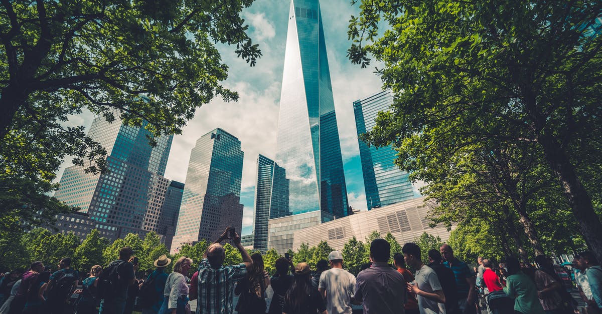 What are the best days to travel around Thanksgiving (US)? - People Standing Across Glass Building What are the best days to travel around Thanksgiving (US)? - People Standing Across Glass Building