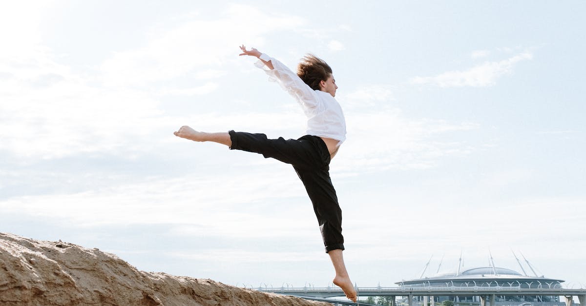 What are the best ways to prevent and/or relieve sand fly bites? - Woman in White Long Sleeve Shirt and Black Pants Standing on Brown Rock Formation Near Body What are the best ways to prevent and/or relieve sand fly bites? - Woman in White Long Sleeve Shirt and Black Pants Standing on Brown Rock Formation Near Body