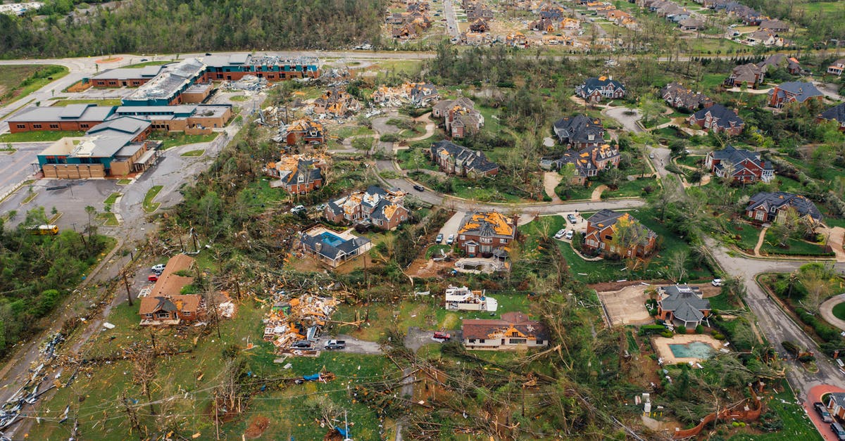 What are the consequences of a small damage on a rented car? [closed] - Aerial view of tornado impact on small settlement cottages with destroyed roofs windthrown trees and bent electricity transmission lines