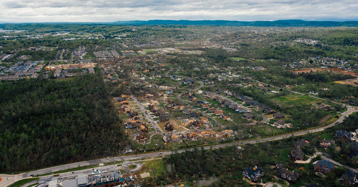 What are the consequences of a small damage on a rented car? [closed] - Aerial view of dramatic consequences of thunderstorm on town suburban district including damaged cottages and uprooted trees