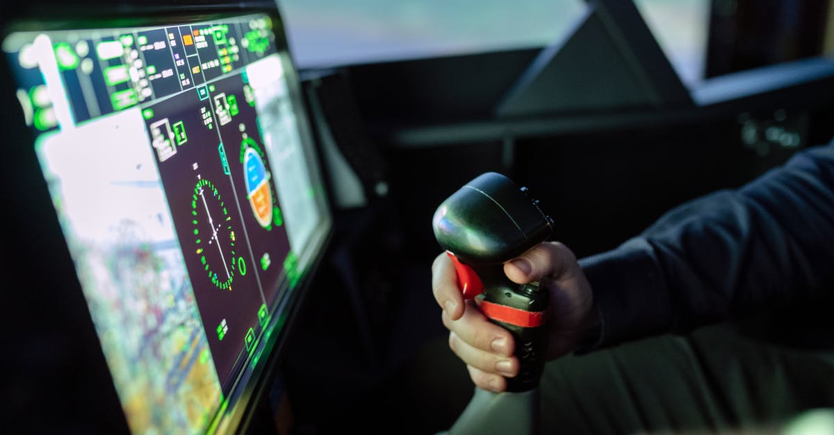 What are the differences between the 'Emirates A380 Experience' and 'iPILOT' flight simulators in Dubai? - Person Controlling Flight Simulator