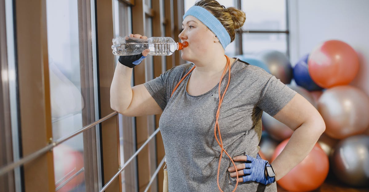 What are the exact reasons why one cannot take a bottle of water on the plane? - Woman Drinking Water in a Gym Room What are the exact reasons why one cannot take a bottle of water on the plane? - Woman Drinking Water in a Gym Room