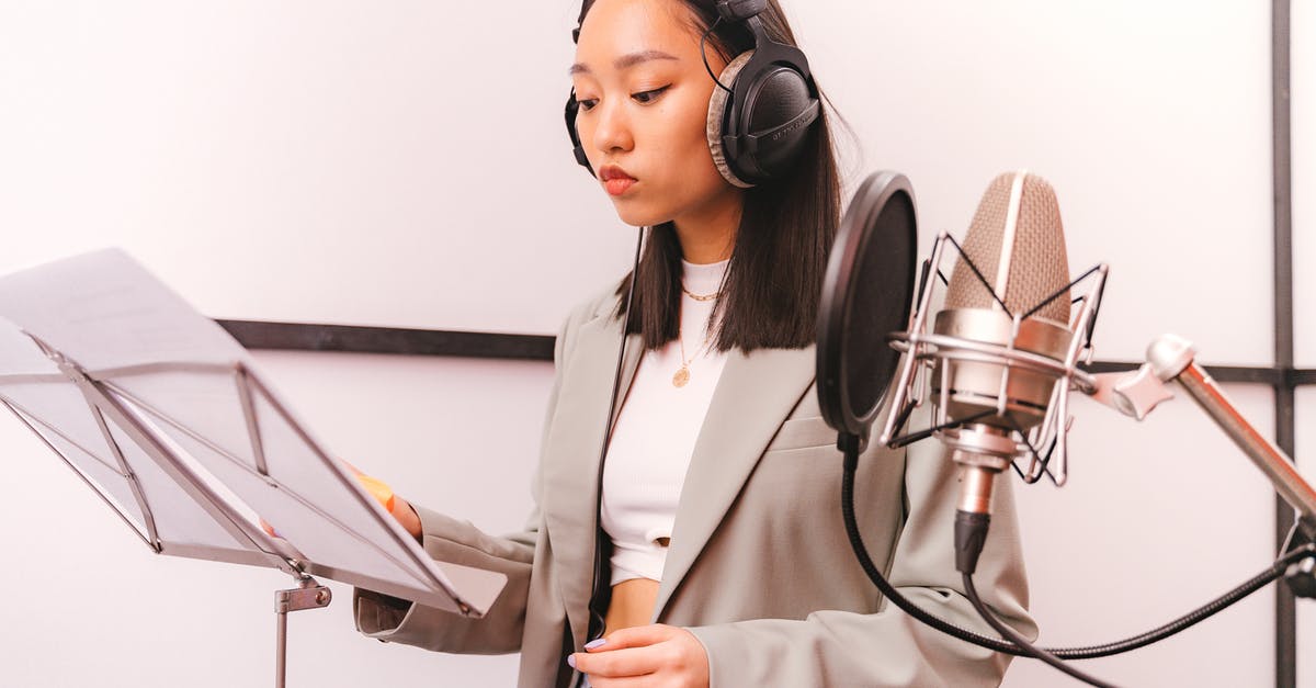 What are the headphones like on the British Airways Boeing 787 economy? [closed] - Woman Wearing Gray Blazer on a Recording Studio