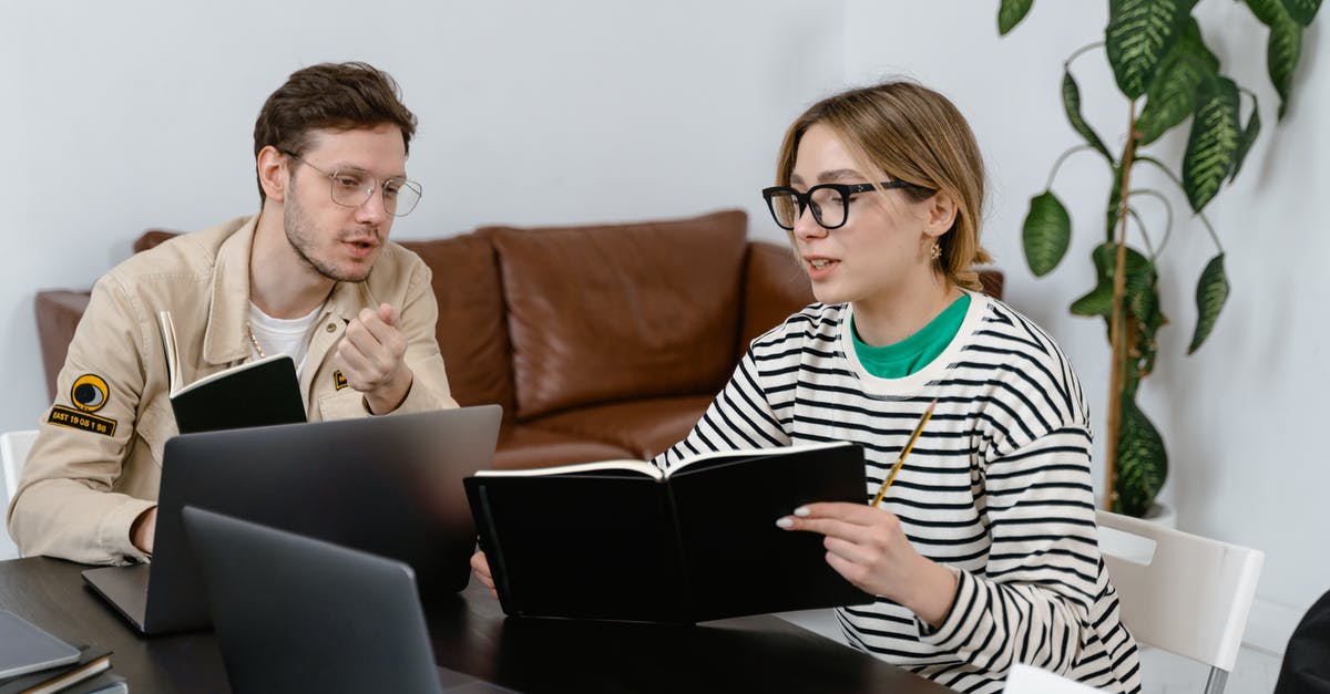 What are the limits when carrying laptops and electronics to USA? - Man and Woman Discussing in Workplace What are the limits when carrying laptops and electronics to USA? - Man and Woman Discussing in Workplace