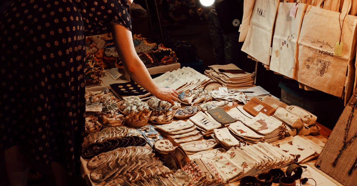 What are the must-buy souvenirs from Ireland? - Anonymous woman buying traditional handmade souvenirs in market What are the must-buy souvenirs from Ireland? - Anonymous woman buying traditional handmade souvenirs in market