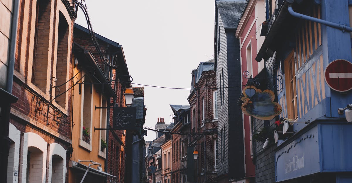 What are the options for booking short-stay accommodation between London and Newcastle at very short notice? - Narrow alley between typical buildings with colorful facade and brick walls located on street in town against cloudless sky in neighborhood What are the options for booking short-stay accommodation between London and Newcastle at very short notice? - Narrow alley between typical buildings with colorful facade and brick walls located on street in town against cloudless sky in neighborhood