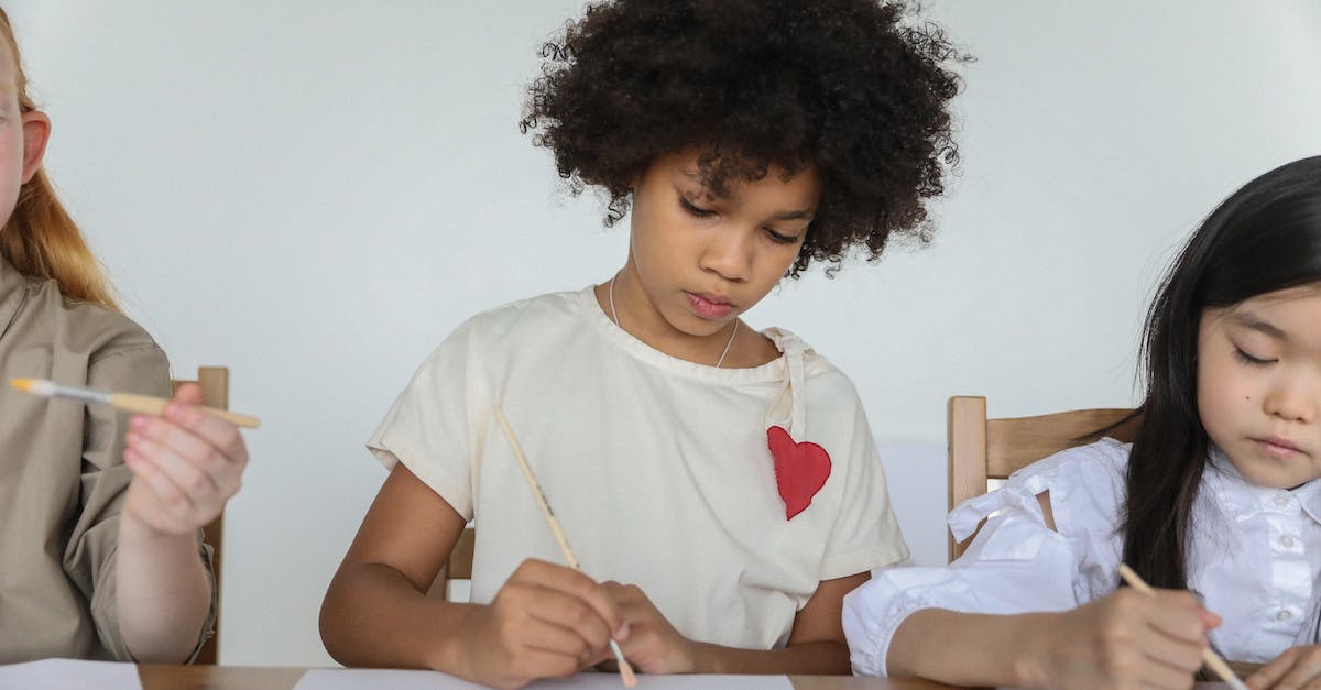 What are the polite ways to draw attention of a waiter around the world? - Focused diverse little girls painting with brushes in art studio What are the polite ways to draw attention of a waiter around the world? - Focused diverse little girls painting with brushes in art studio