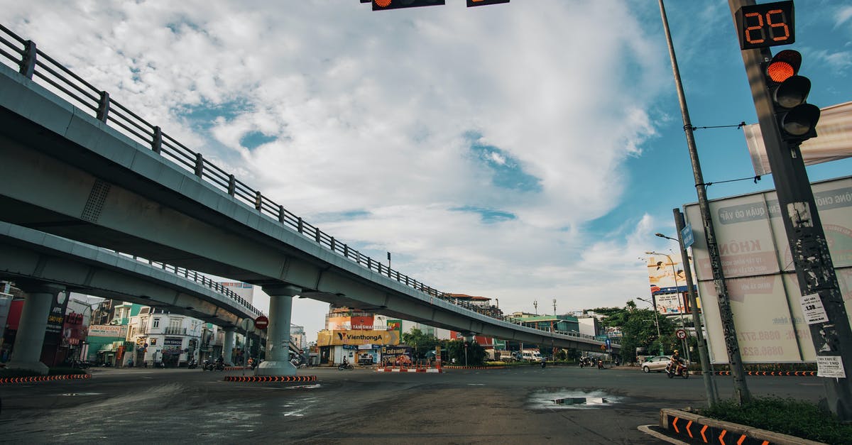 What are the rules around intersections with flashing lights? - Low angle of empty asphalt crossroad with red traffic light with timer in center of city What are the rules around intersections with flashing lights? - Low angle of empty asphalt crossroad with red traffic light with timer in center of city